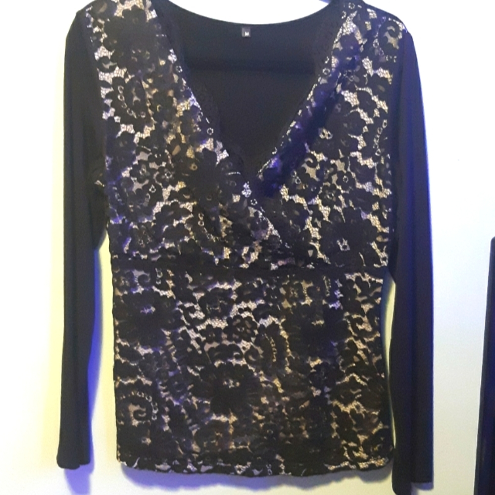 Very pretty black top with lace over lay on front. NWOT